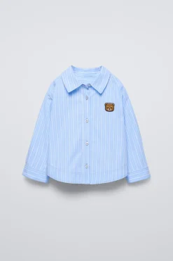 CAMISA RAYAS PARCHE OSO