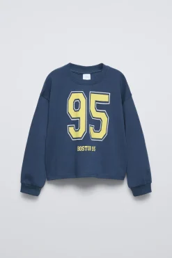 CAMISETA VARSITY TEXTO