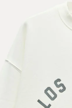 SUDADERA EFECTO LAVADO TEXTO ENGOMADO